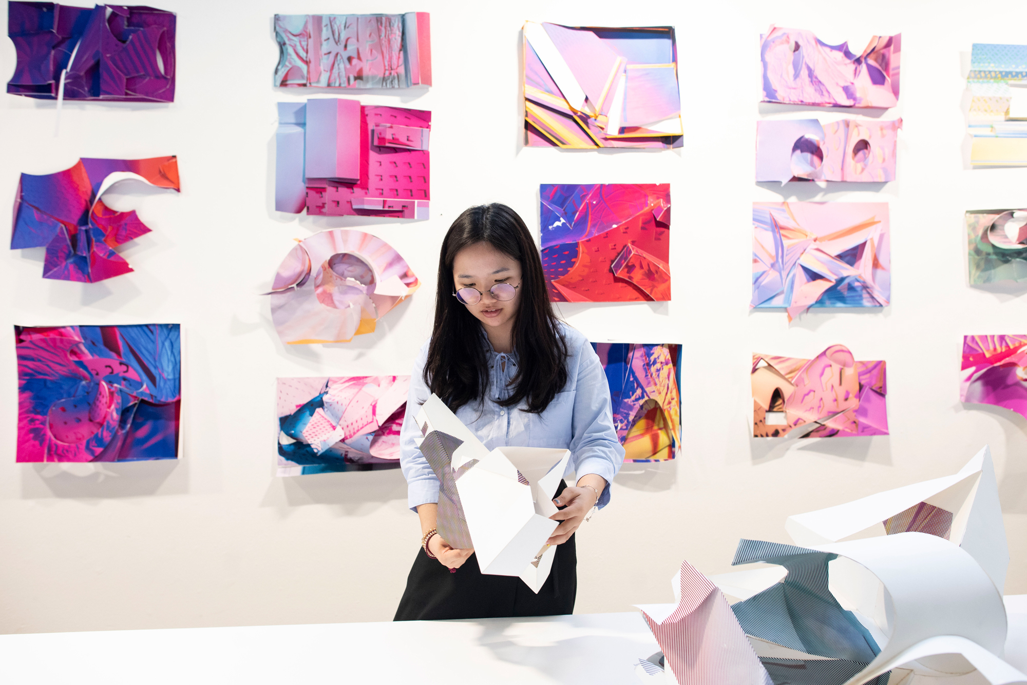 student holding project colorful exhibition