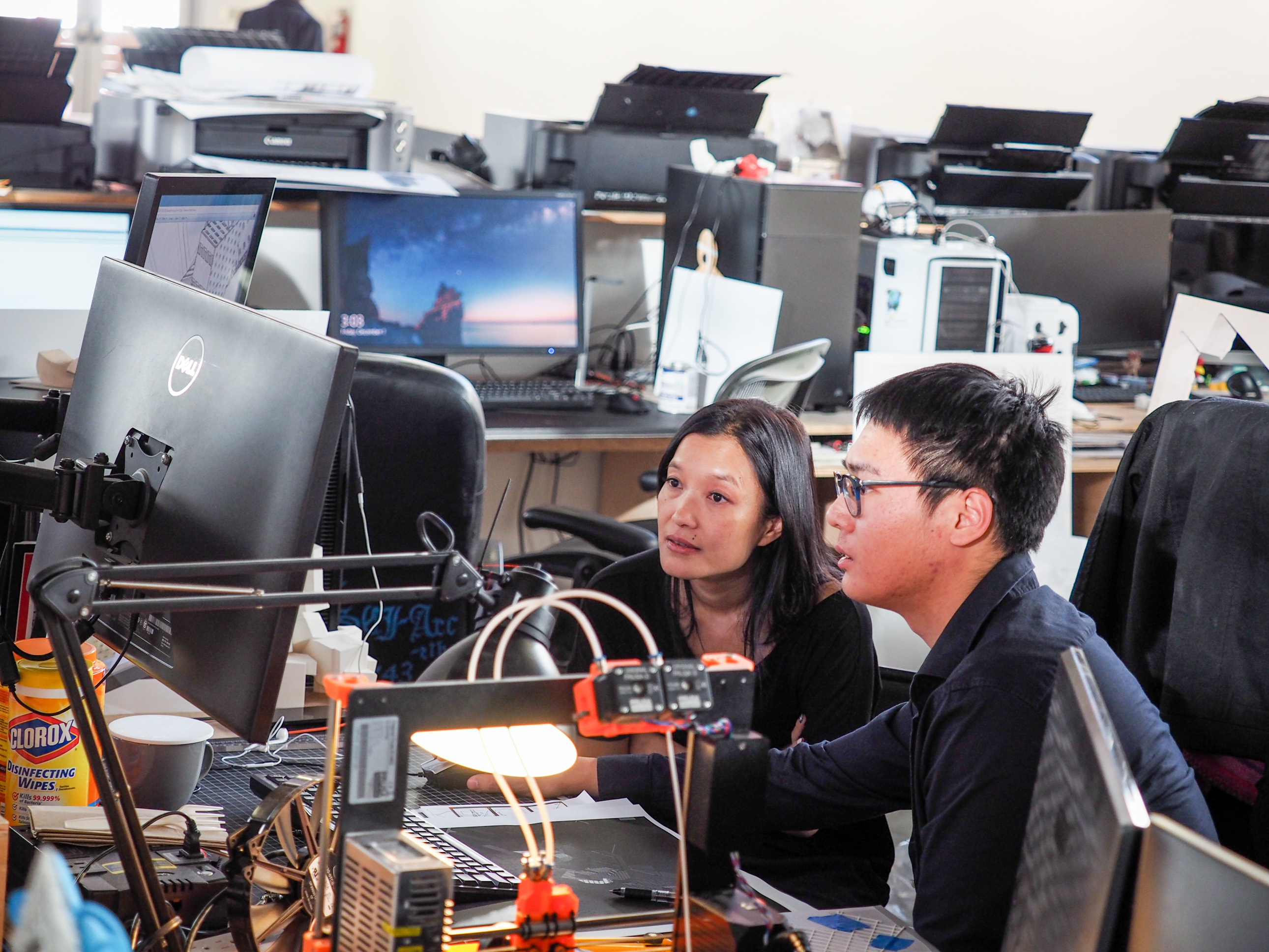 student faculty sitting working computers