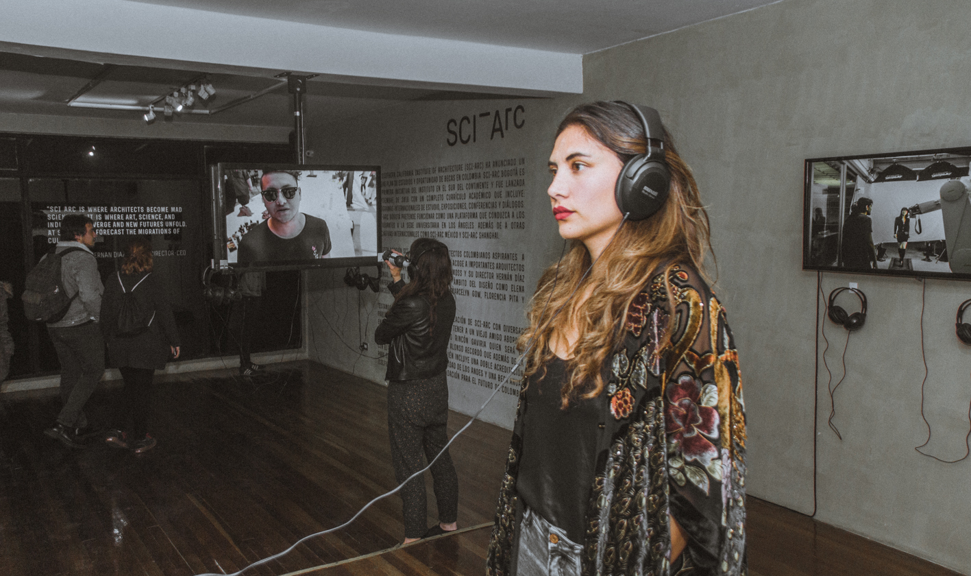 female architecture enthusiast headphones within exhibition