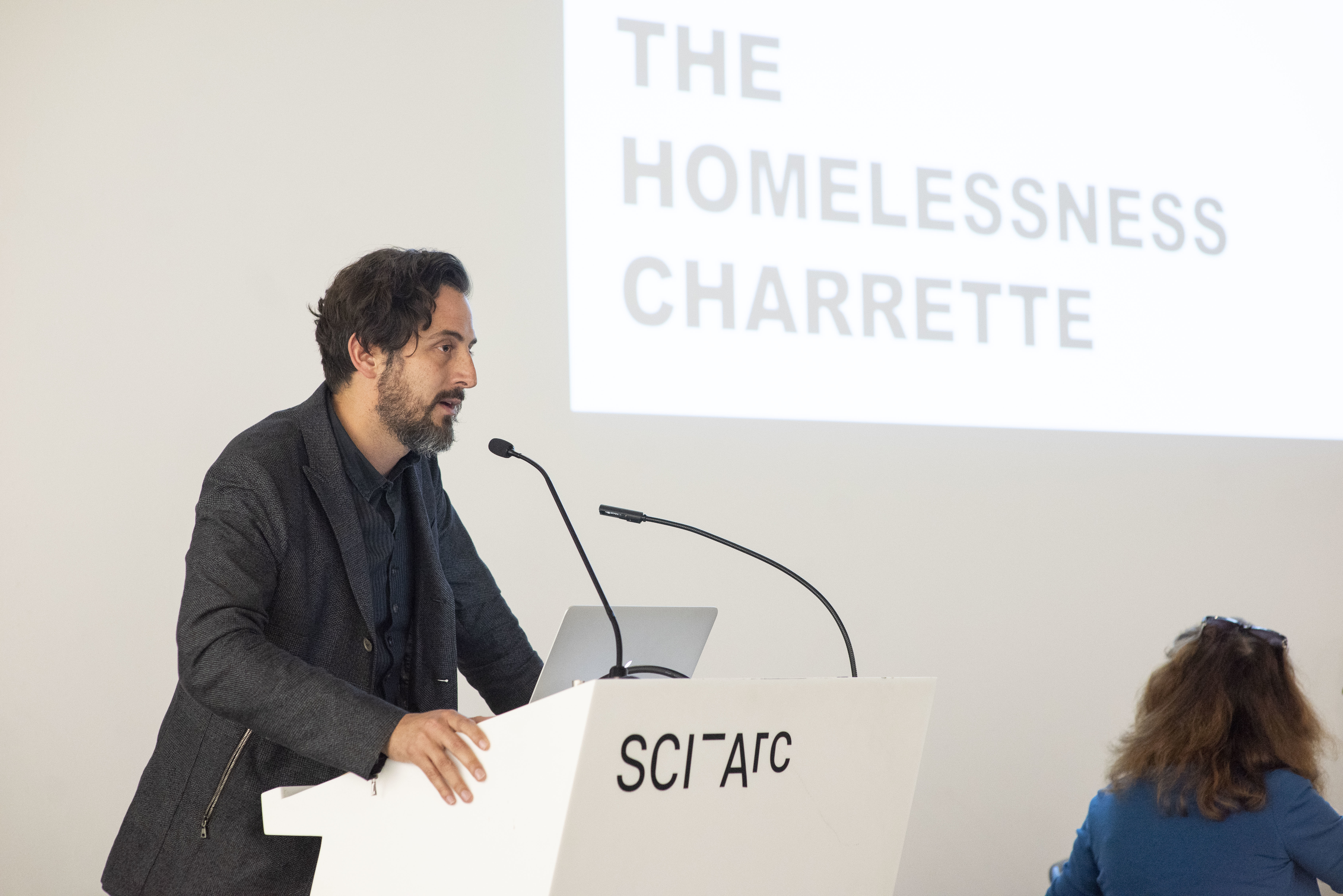 Homelessness Charrette presenter at podium