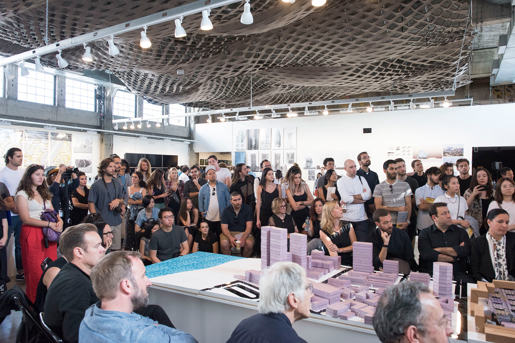 students watch graduate thesis presentation and critique