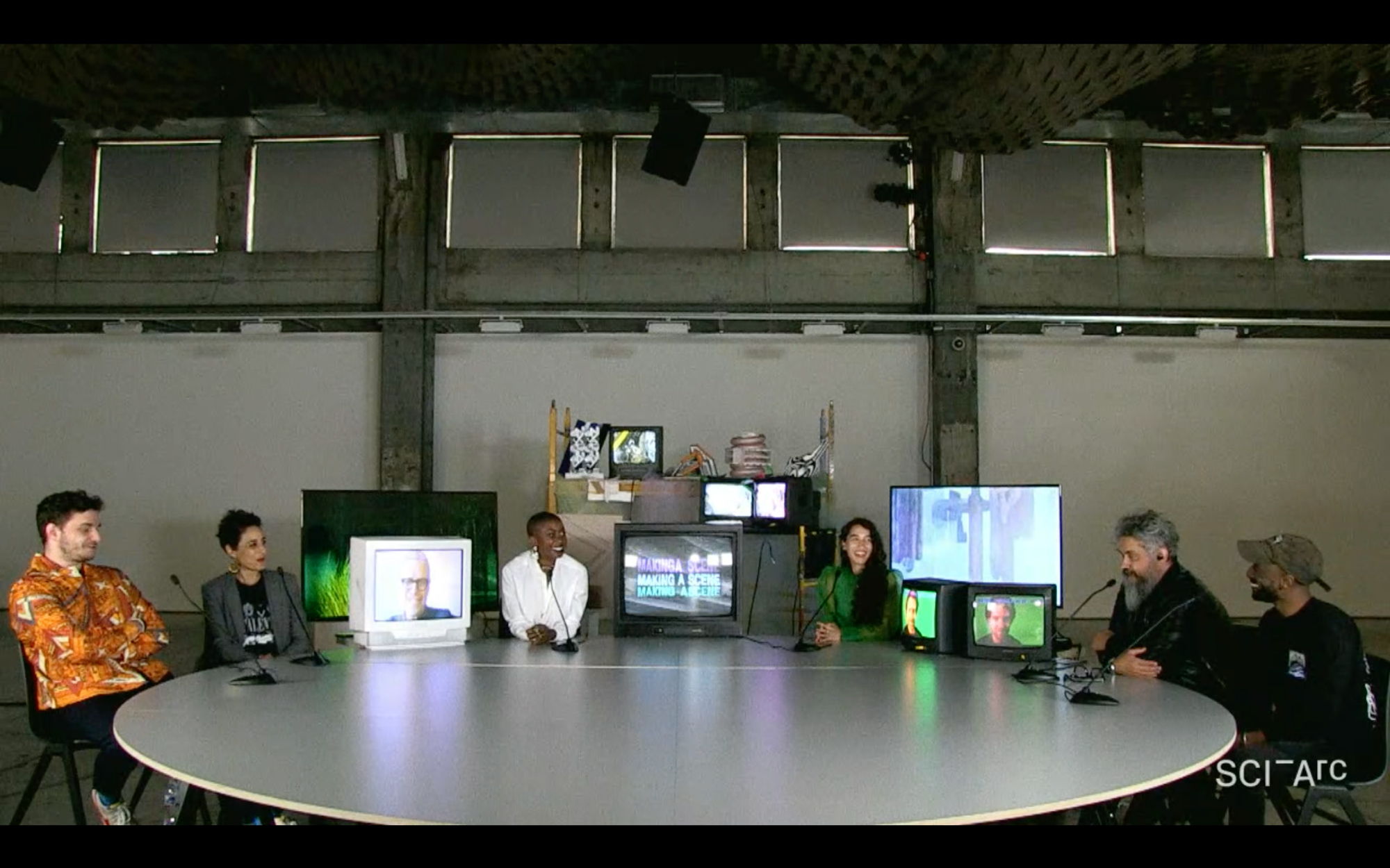 people round table tv screens