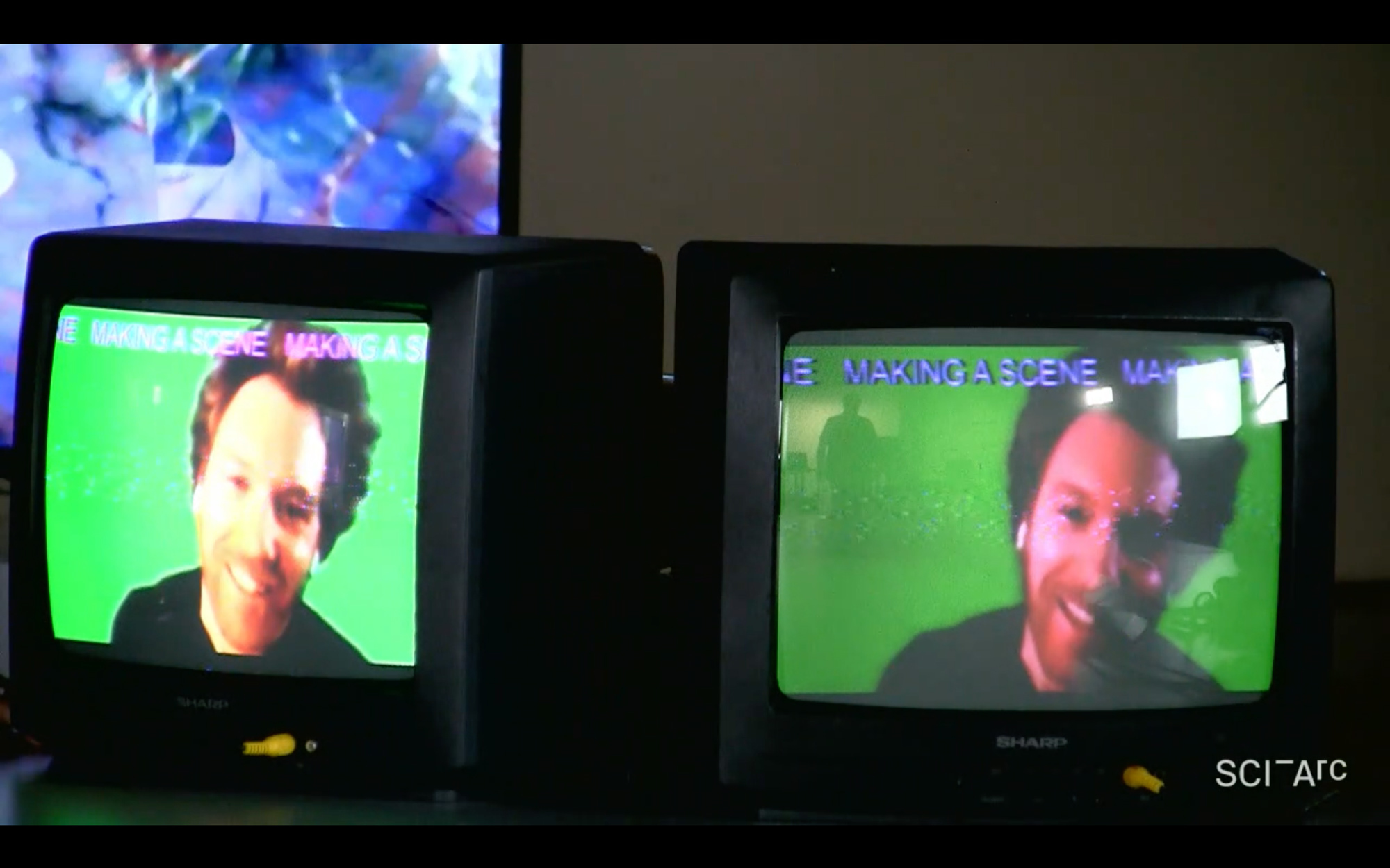 two screens man smiling green screen