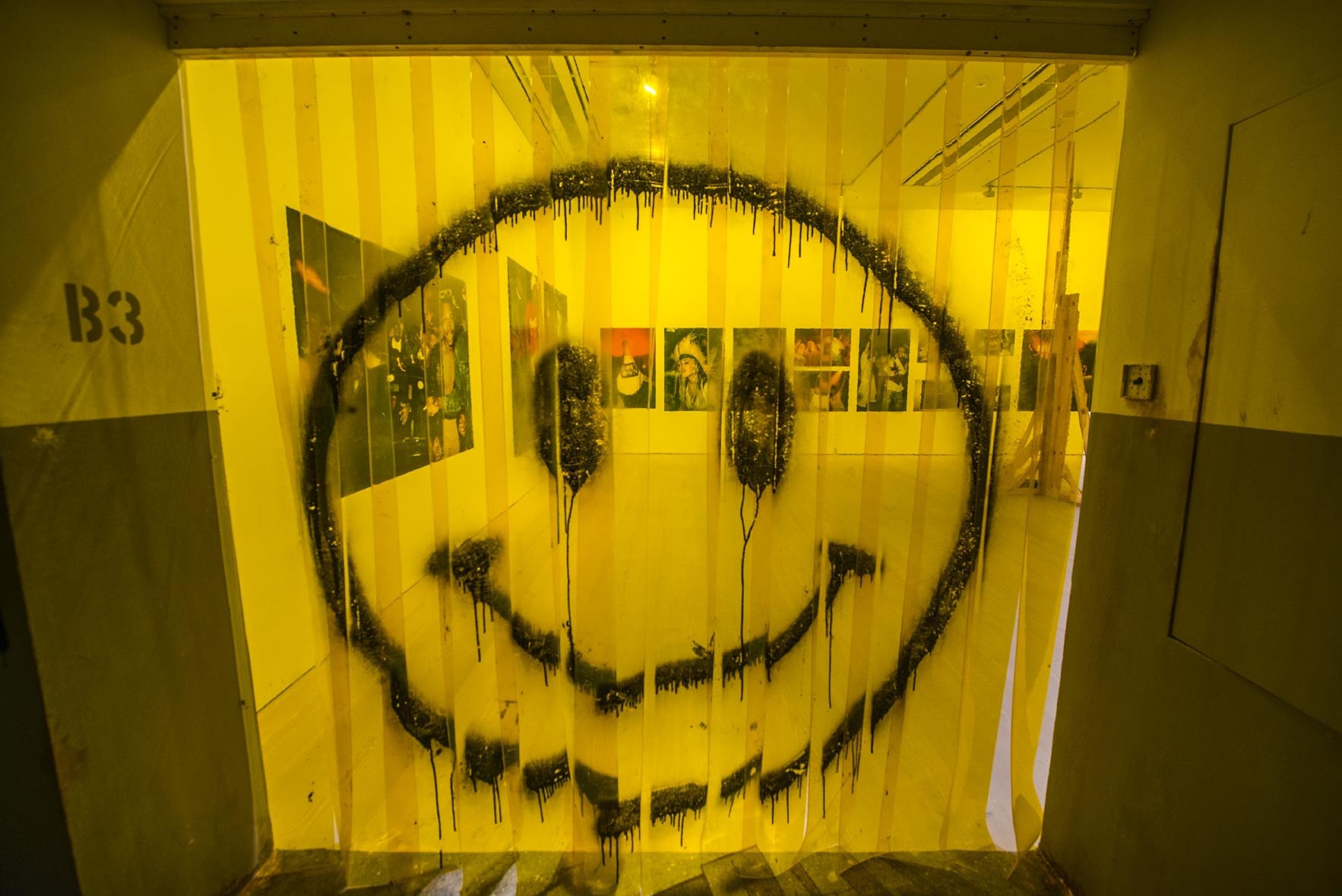 Saatchi gallery yellow curtain smiley face art