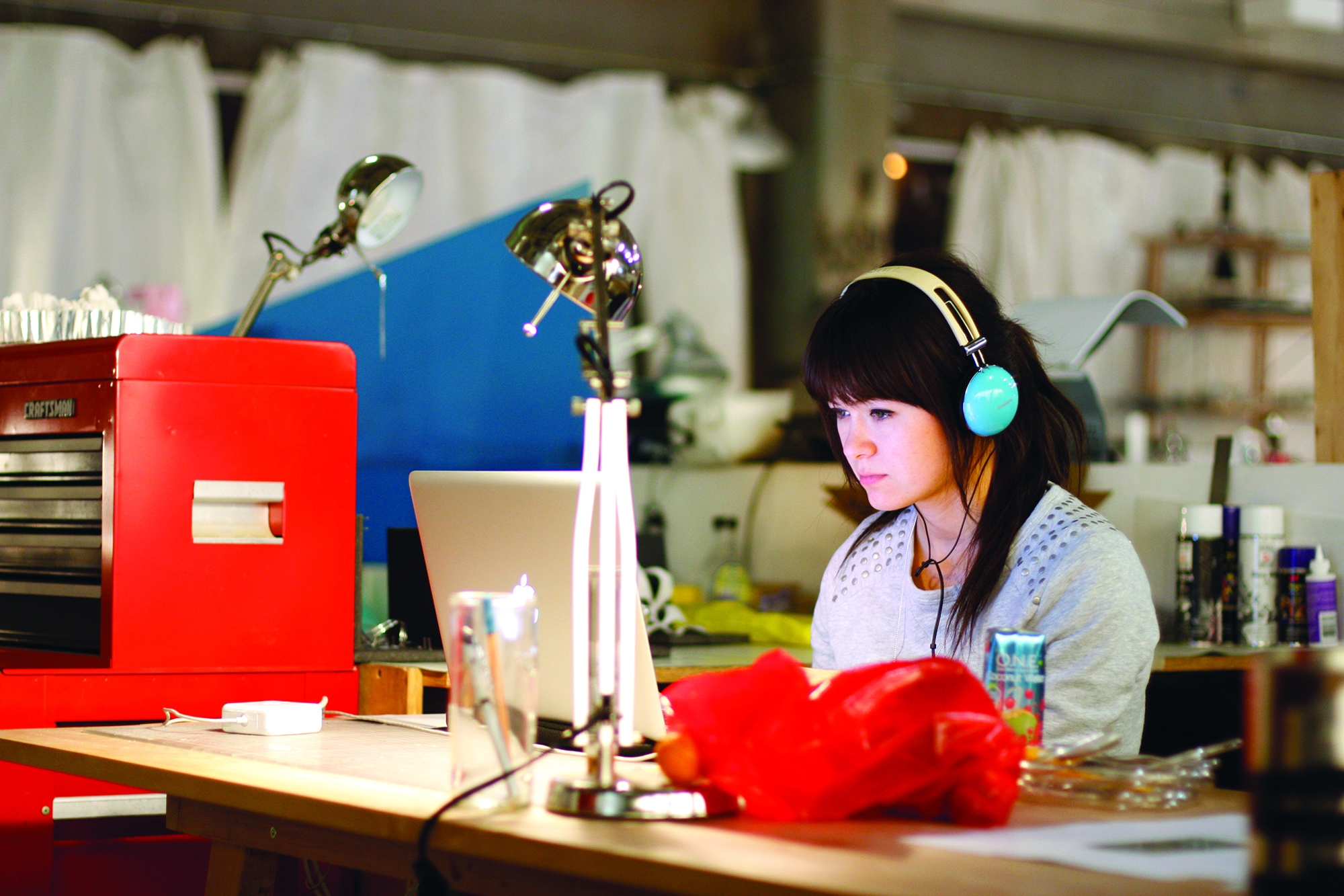 student in headphones works at desk