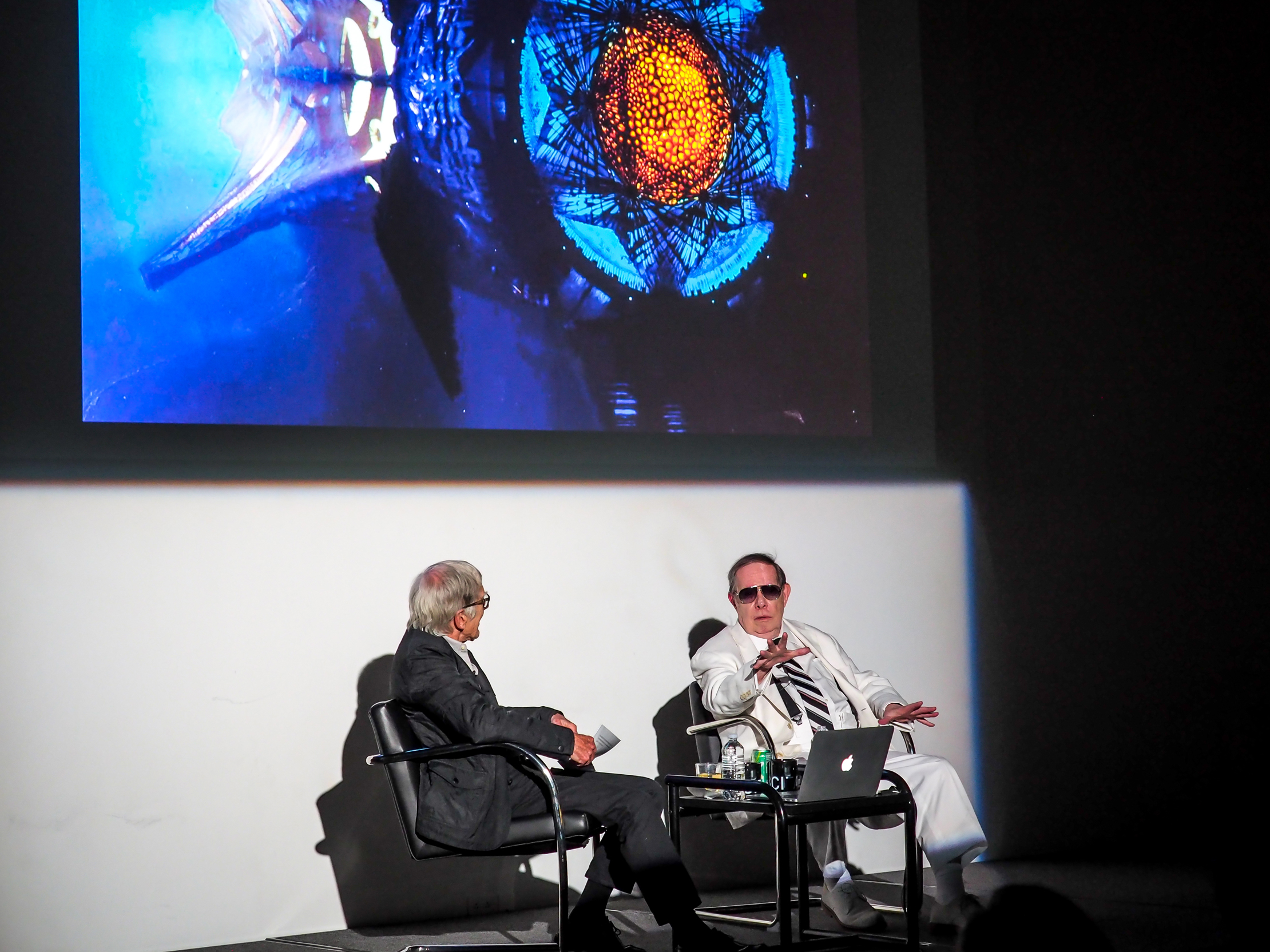 two men in suits on stage