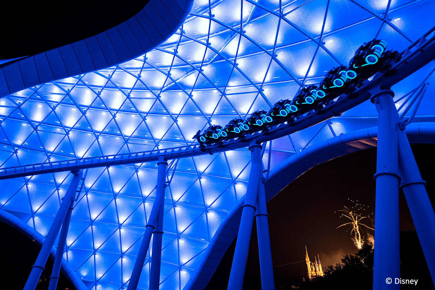 • The soaring canopy of TRON Lightcycle / Run illuminates the Tomorrowland skyline at Magic Kingdom Park at Walt Disney World Resort.