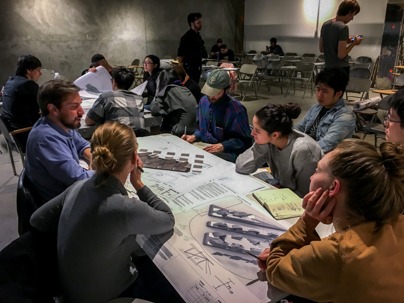 faculty with student groups in classroom in architecture school