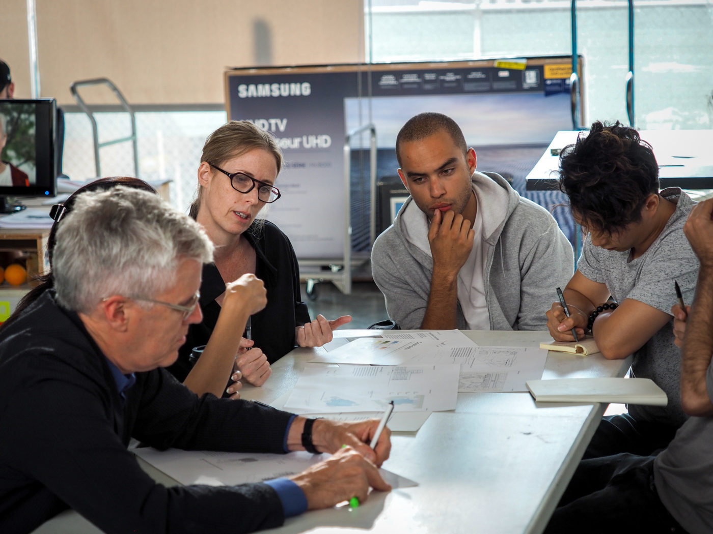 professors and students converse over work