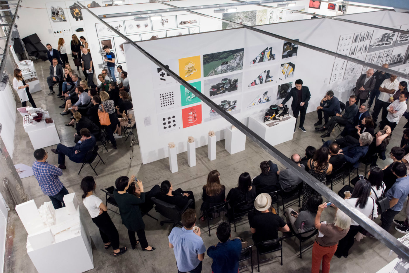 simultaneous undergraduate thesis presentations keck hall with crowds looking at architecture presentation in SCI-Arc
