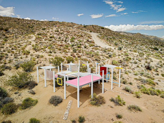 white extrusions pink rectilinears in dessert environment