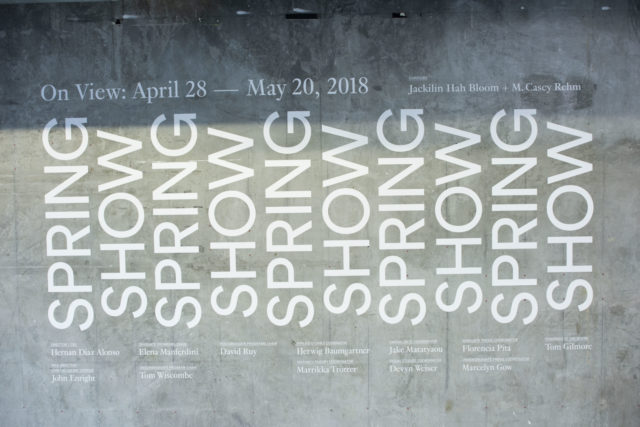 white text on concrete wall spring show 2018