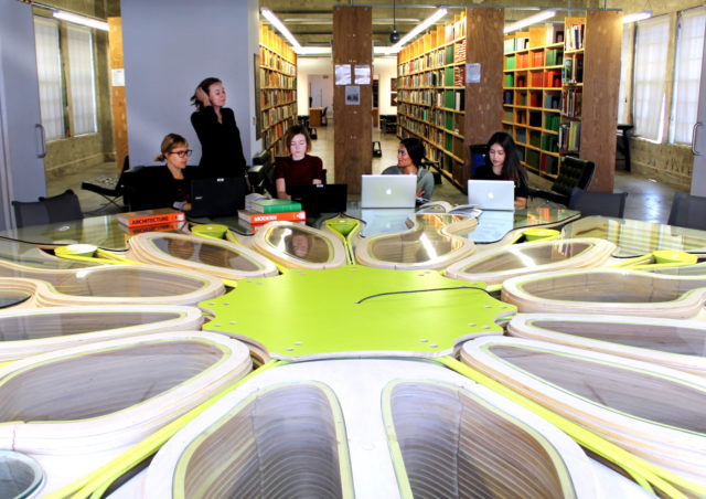 women of architecture gathered library table