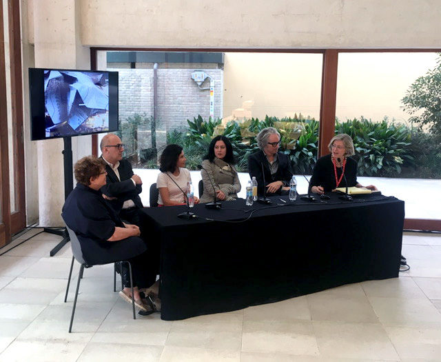 architecture enthusiasts gathered around black table