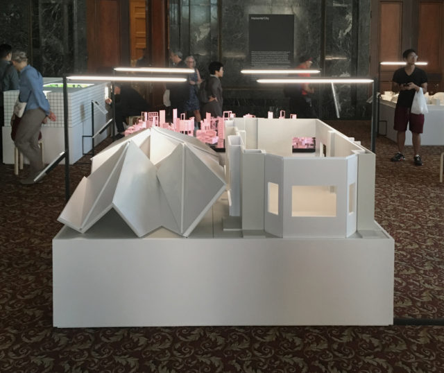 architectural model on low podium carpeted gallery