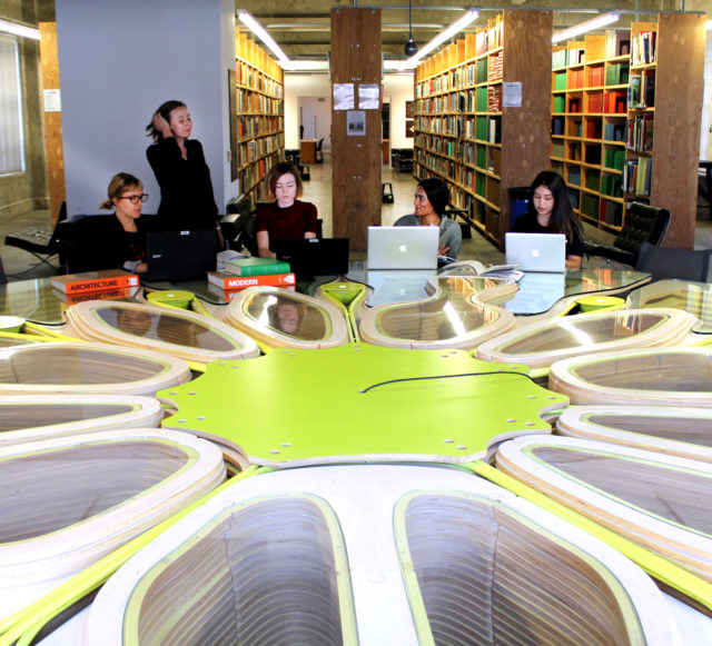 women of architecture gathered library table