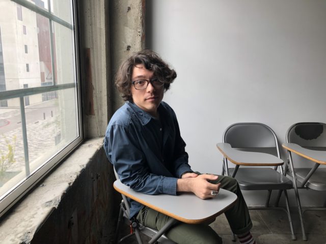 student sitting at desk in classroom