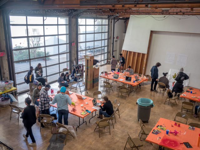 tall ceiling workshop creators orange tapestry plastic tables