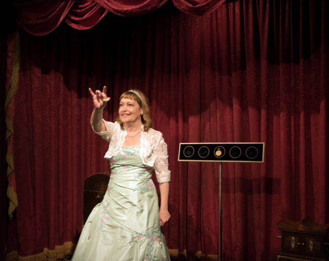 lisa cousins in gown infront of velvet curtain