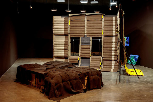 tufted wall with apertures and cushion in gallery