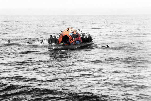 people boat raft on ocean orange tent