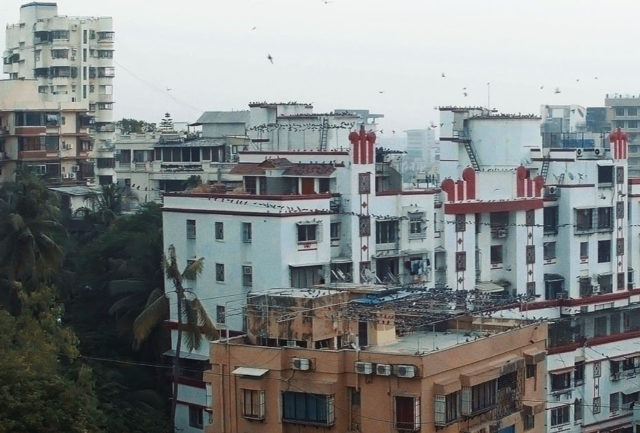 white building in mumbai red accents city context