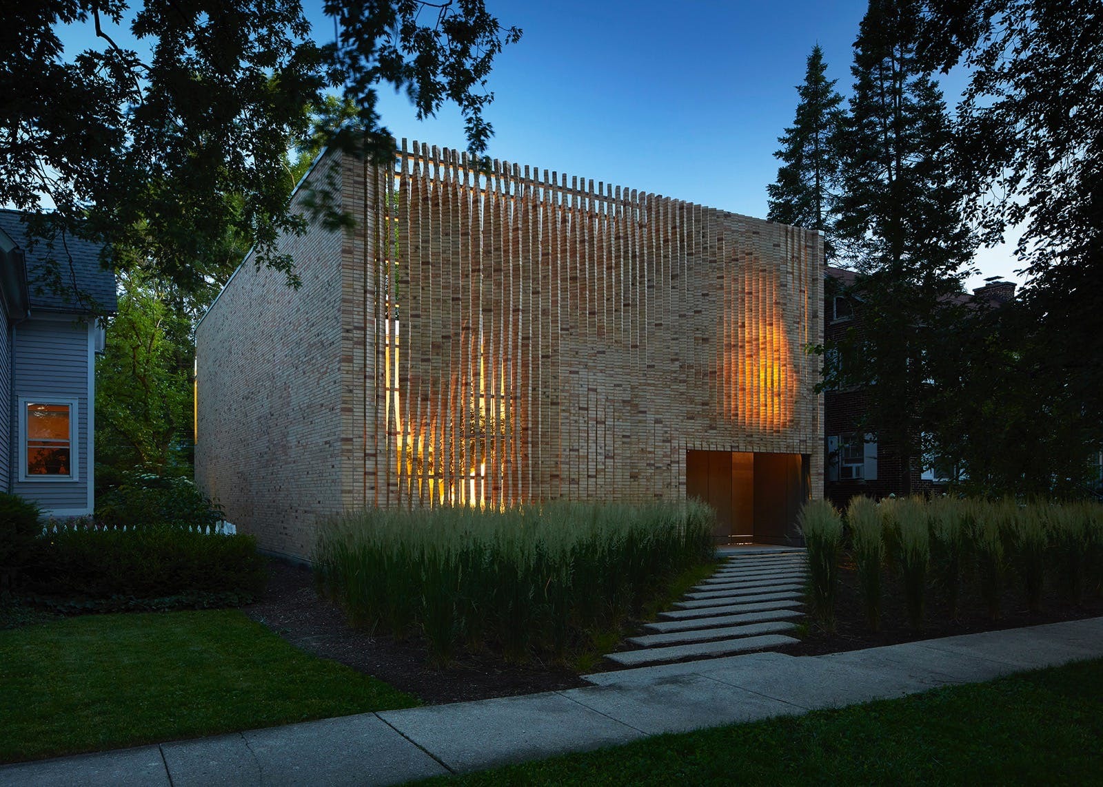 a brick home with brick louvers by Brooks and Scarpa