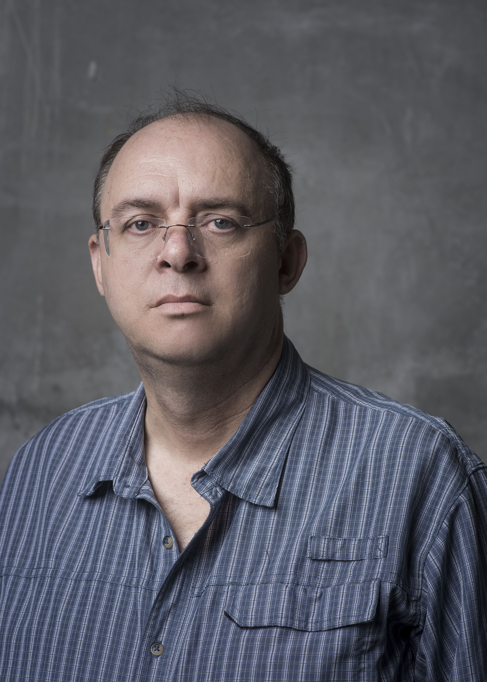 graham harman with glasses portrait in blue stripes grey background