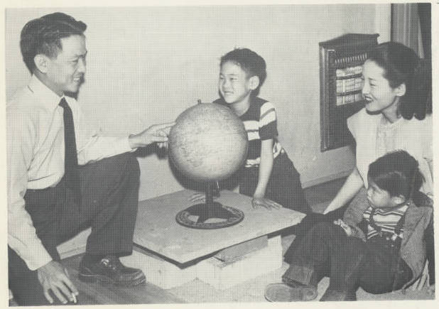 archive photo asian family smiling around globe