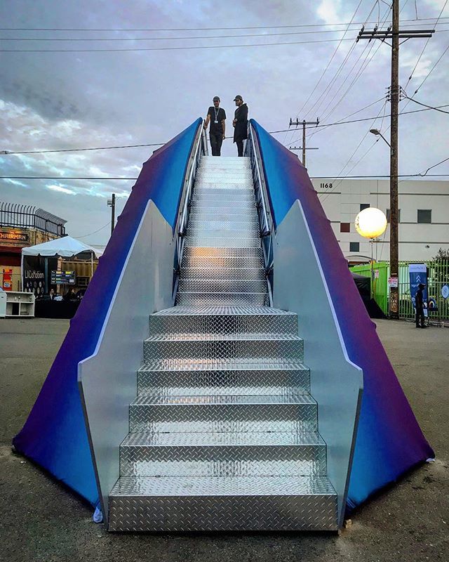 diamond treaded steel staircase flanked with gradient blue panels