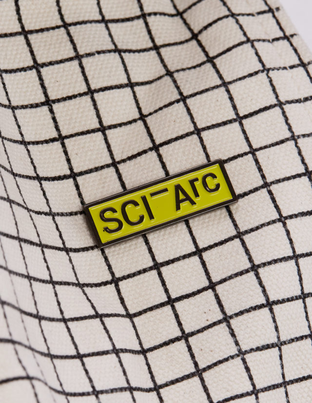 sciarc yellow enamel pin on fabric