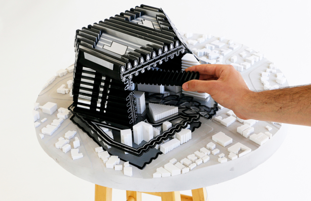 black contemporary architecture model with off white model base hand reaching
