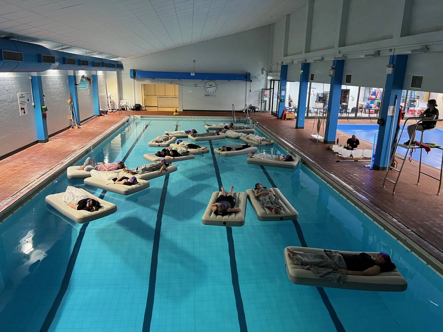 People Relaxing on Air Bed in Swimming Pool, Listening to Sound Bolws Being Played, coyama.live