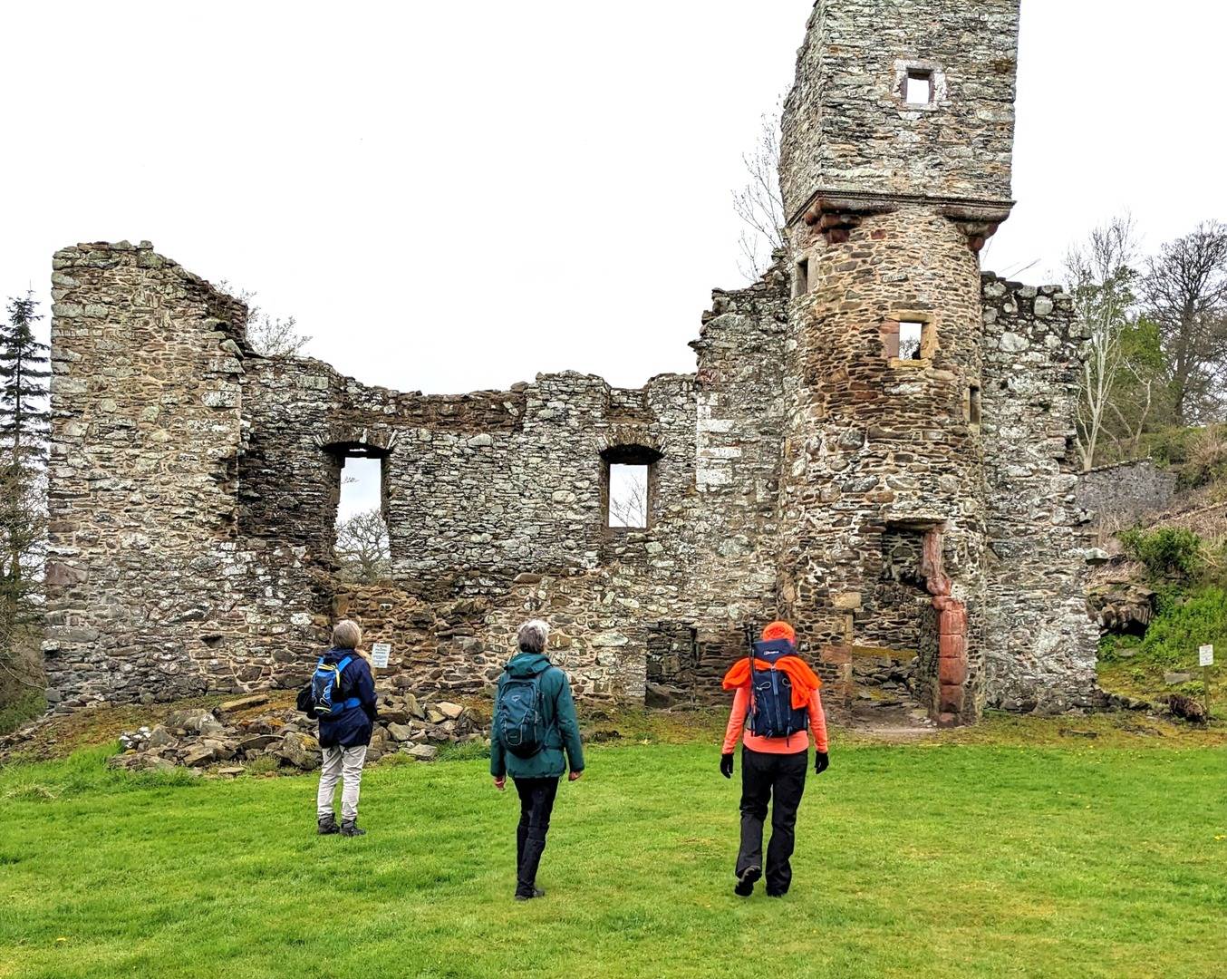 Three walkers looking at ruins of Torwoodlee Tower Galashiels, Hike & Bike Hub