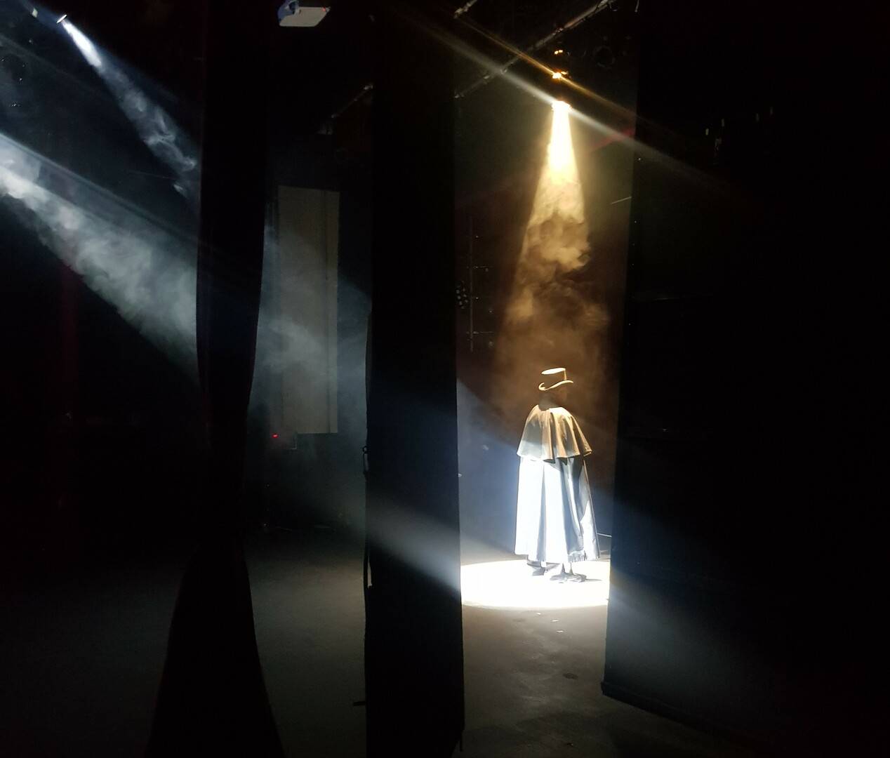 Storyteller John HIll standing on the stage at the Theatre Royal in Dumfries, wearing a top hat and long black cape., Mostly Ghostly