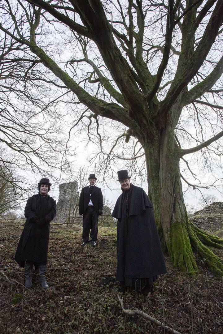 Thee costumed storytellers standing in the atmospheric woodlands near Lochmaben Castle., Allan Devlin