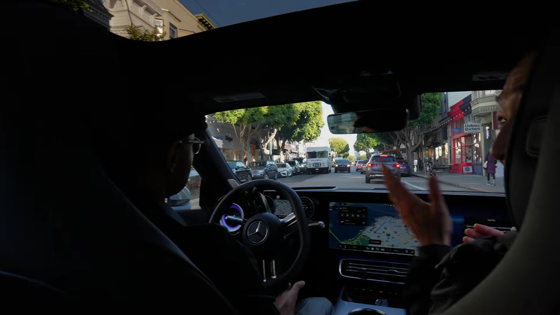 A 'Battle of the Bots' moment where the NVIDIA test car encounters a Waymo robotaxi at an intersection, requiring complex negotiation.
