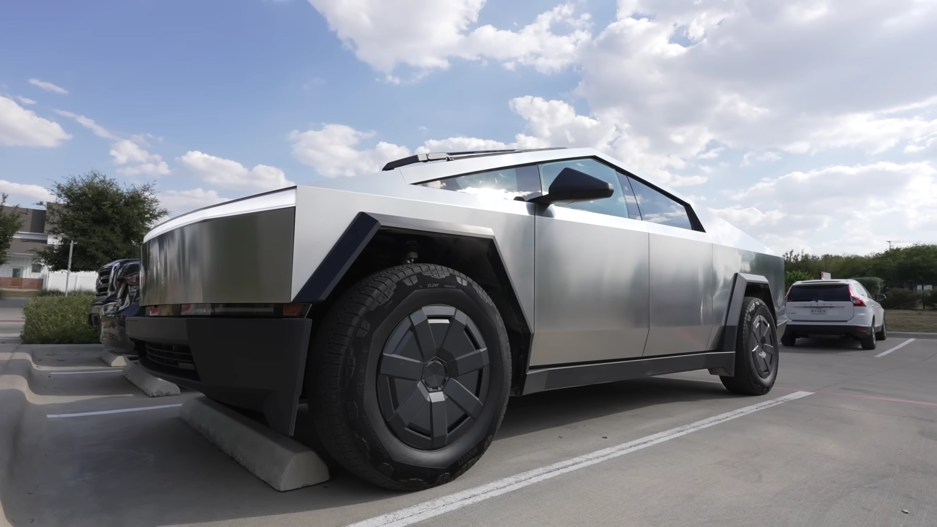 The Cybertruck raising its ride height uniformly using its adaptive air suspension system.