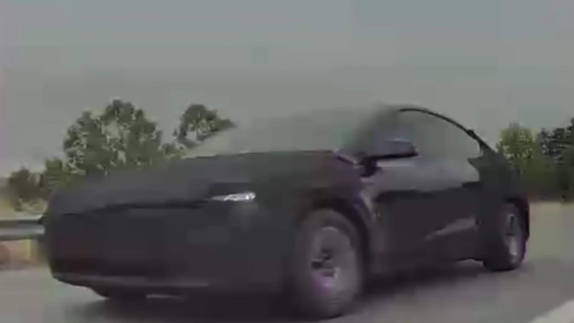 The center display of a 2023 Model X showing a functional front bumper camera feed after a successful DIY retrofit.