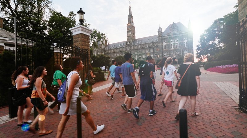 High school students walking towards Healy Hall on Georgetown campus.