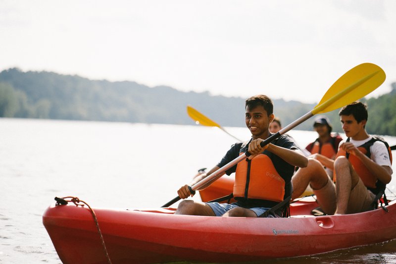 Students in life jackets in a kayak on the Potomac River.