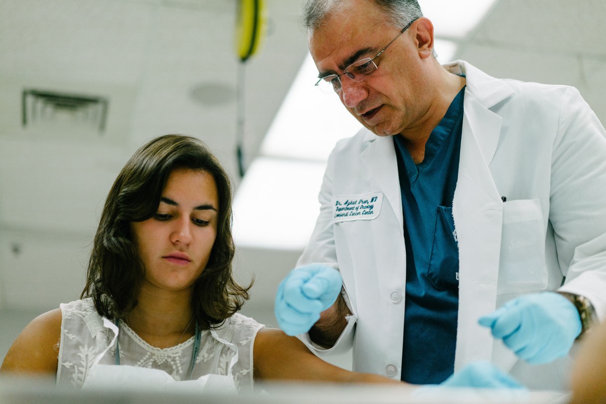 Georgetown University medical instructor guiding a student during a hands-on anatomy or clinical training session in a lab.