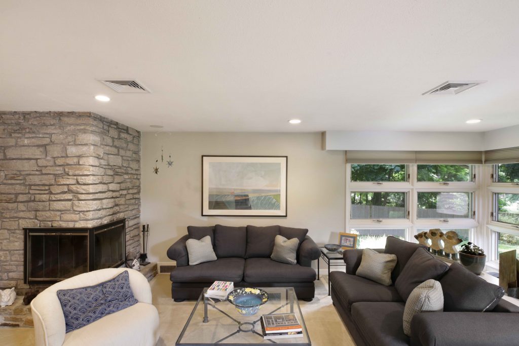 A ducted heat pump system distributes air through vents in this living room.