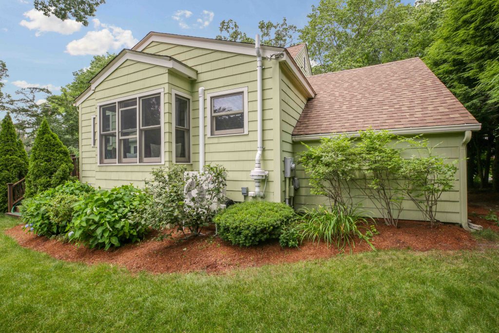 Shrubs disguise the outdoor unit at this suburban home.