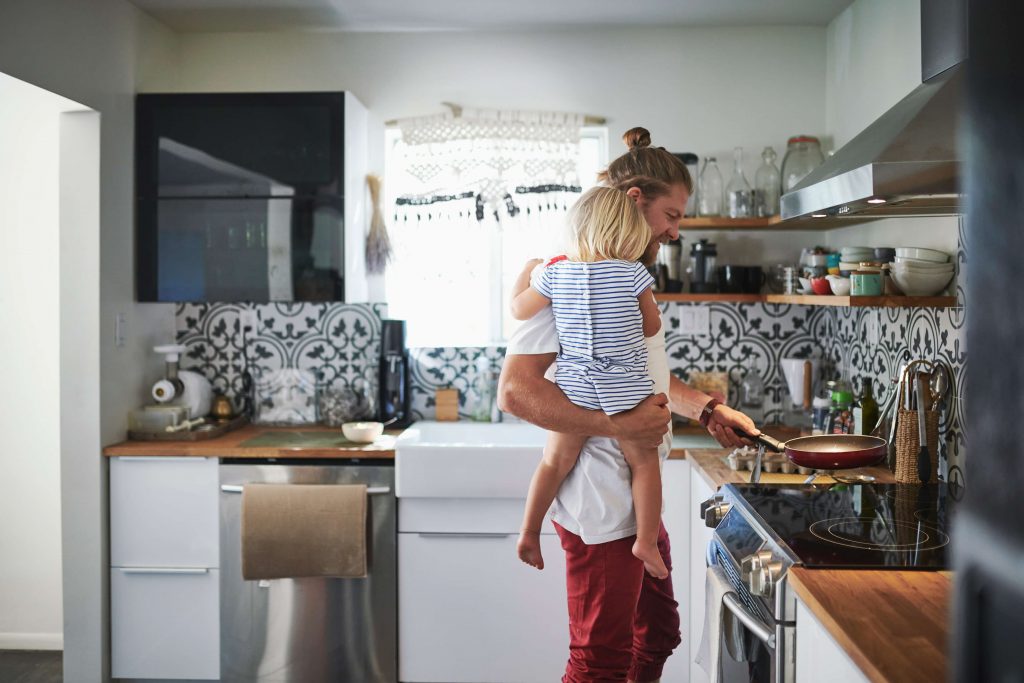 Family cooking healthily with electric stove