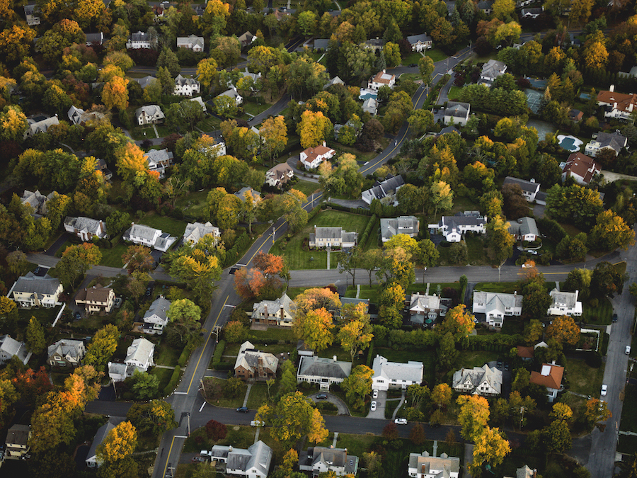 Drone shot of neighborhood with trees and houses as an example of collecting data for HOMES rebate program