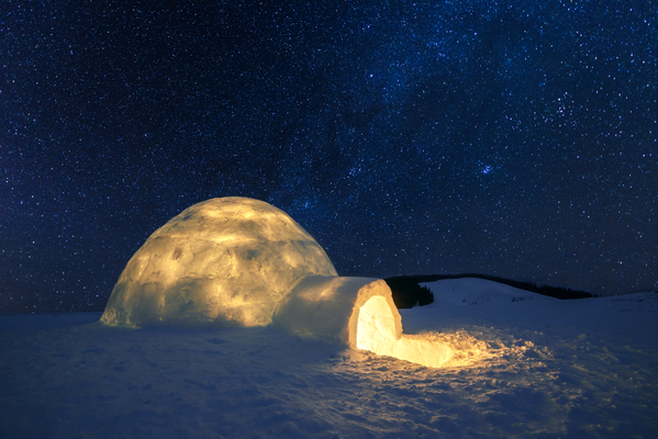 A beautiful igloo at night lit up from inside can keep people warmer through the power of insulation