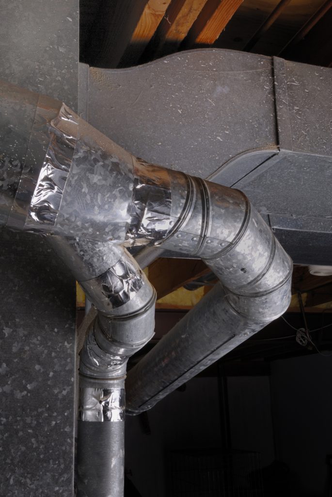 Exposed ducts in central HVAC system are treated with metal tape to eliminate duct leaks