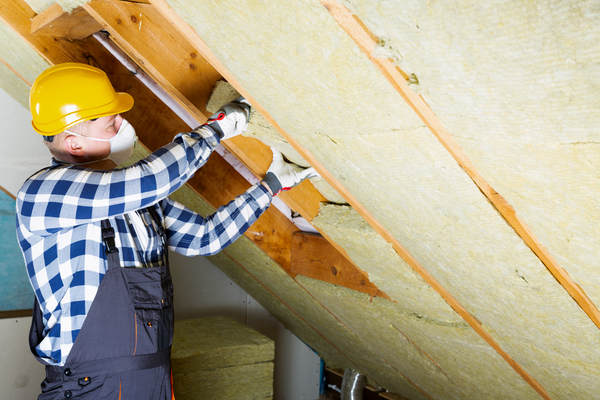 A Sealed installer replaces insulation in an attic.