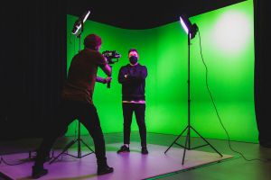 Video filming in front of a green screen.